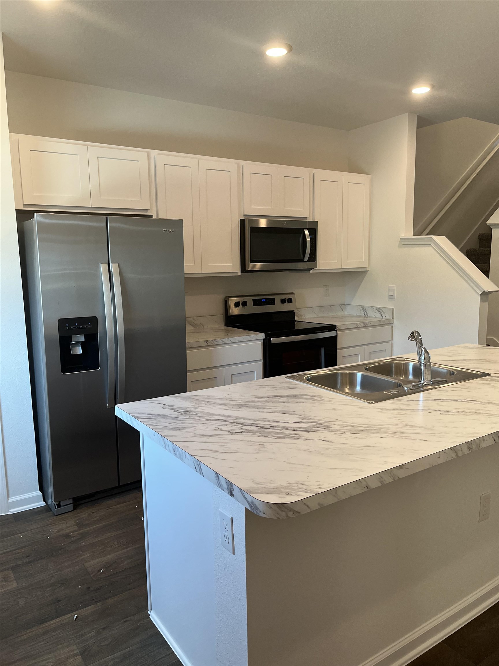 102 Vidalia Ridge Rd Street St. Augustine, FL 32084 - Photo 3 of 29 a kitchen with stainless steel appliances wooden cabinets a refrigerator and a sink