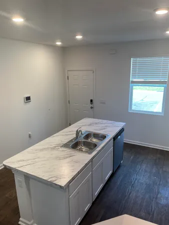 a kitchen that has a sink and a stove