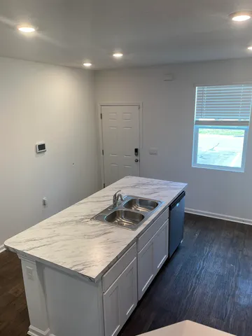 a kitchen that has a sink and a stove