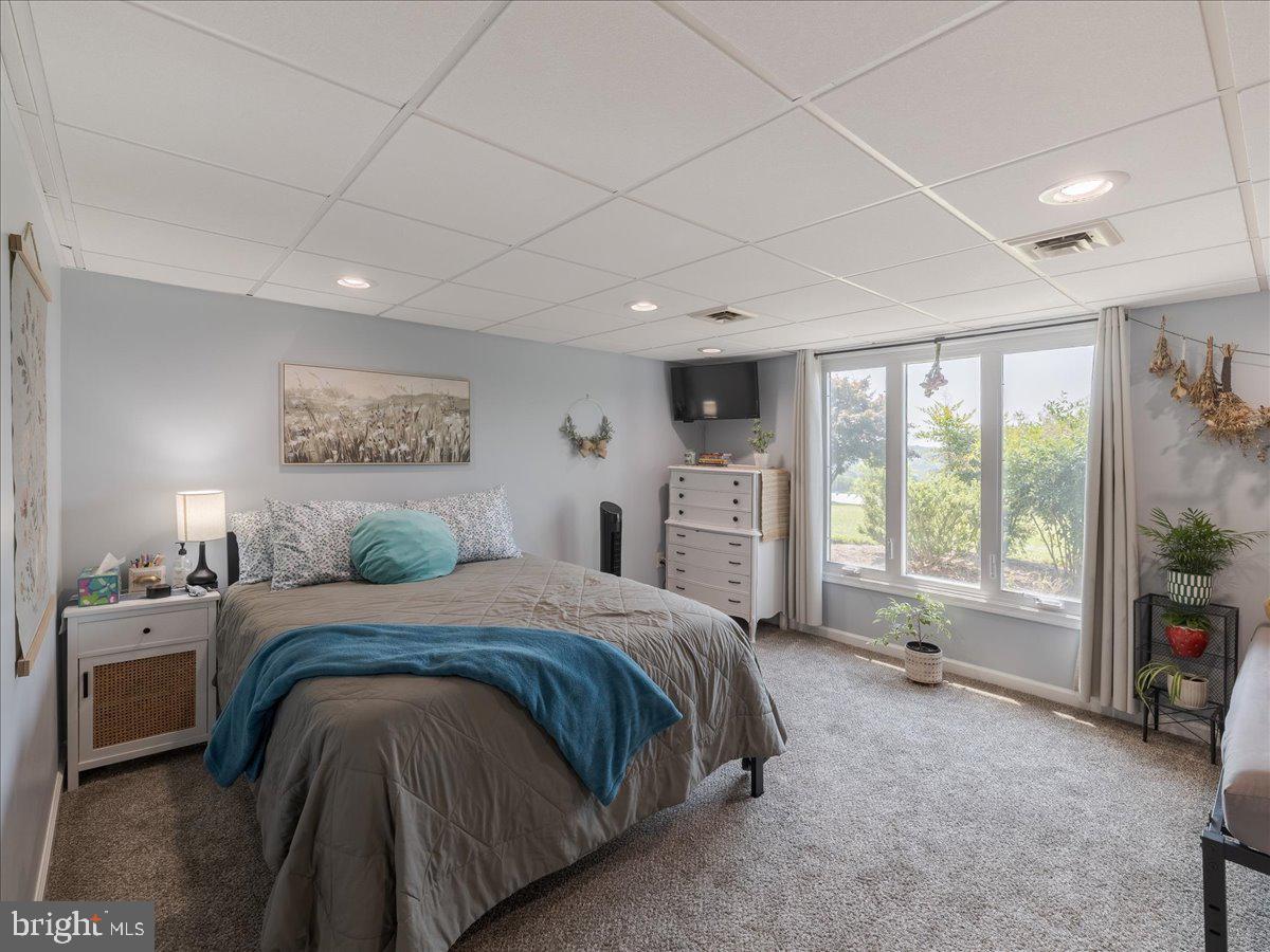 102 Upper Valley Road Christiana, PA 17509 - Photo 35 of 75 a spacious bedroom with a bed a table and large window