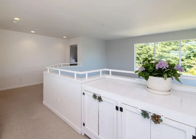a bathroom with a double vanity sink a mirror and a potted plant