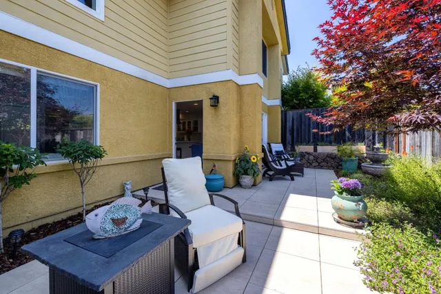 a view of chair and table in back yard of garden