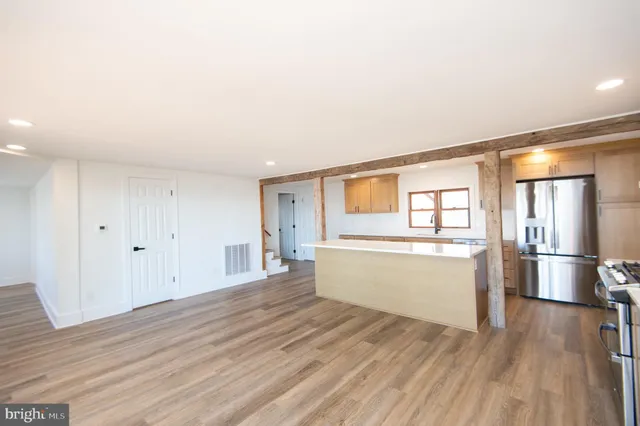 a living room with furniture a fireplace and a chandelier