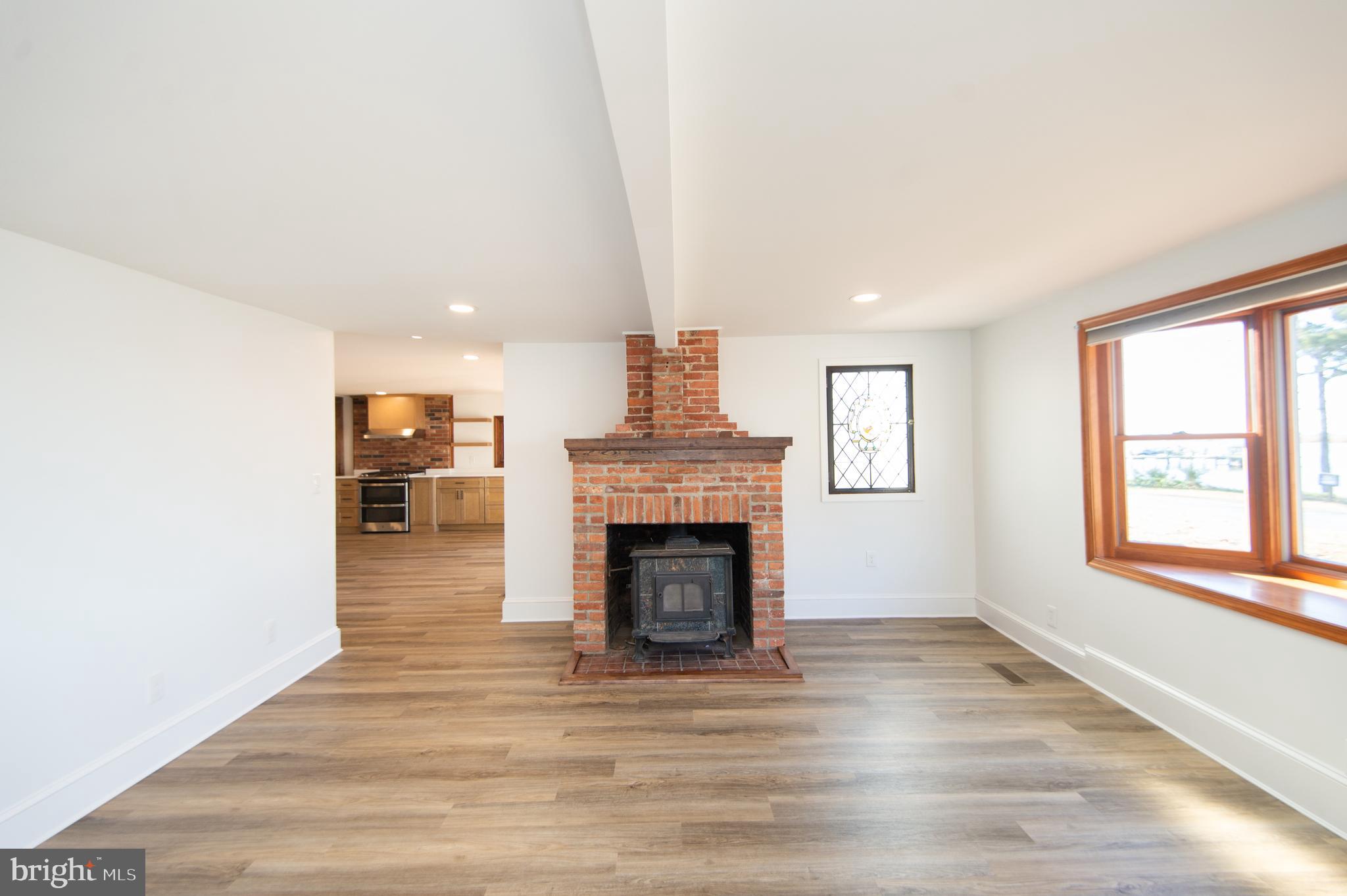 11453 Riverton Road Mardela Springs, MD 21837 - Photo 20 of 71 a view of a livingroom with a fireplace wooden floor and windows