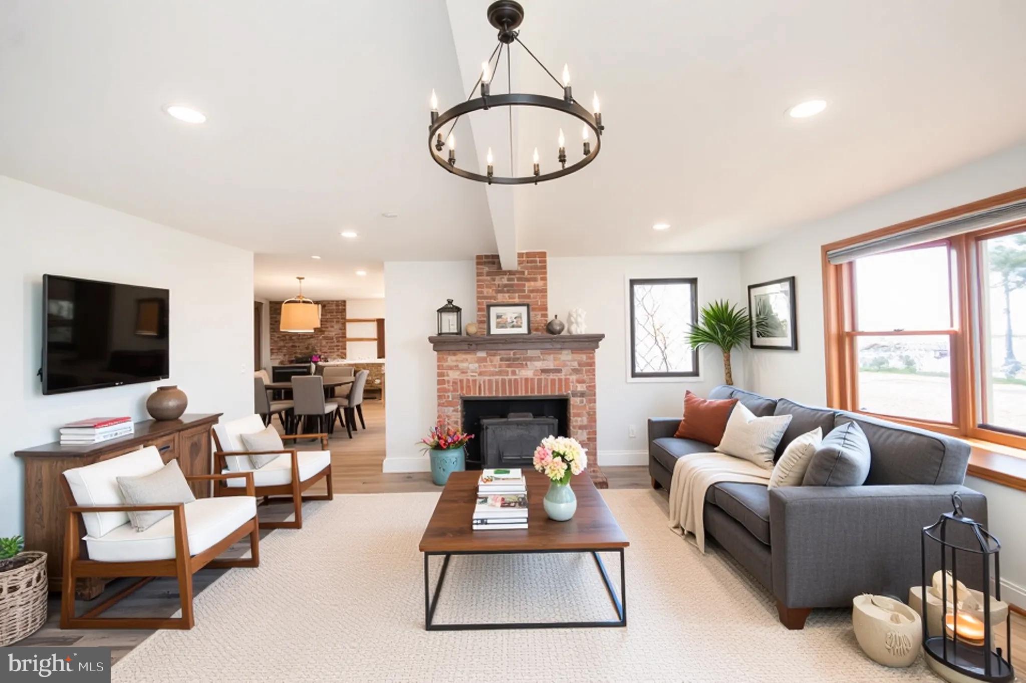 11453 Riverton Road Mardela Springs, MD 21837 - Photo 23 of 71 a living room with furniture a fireplace and a flat screen tv