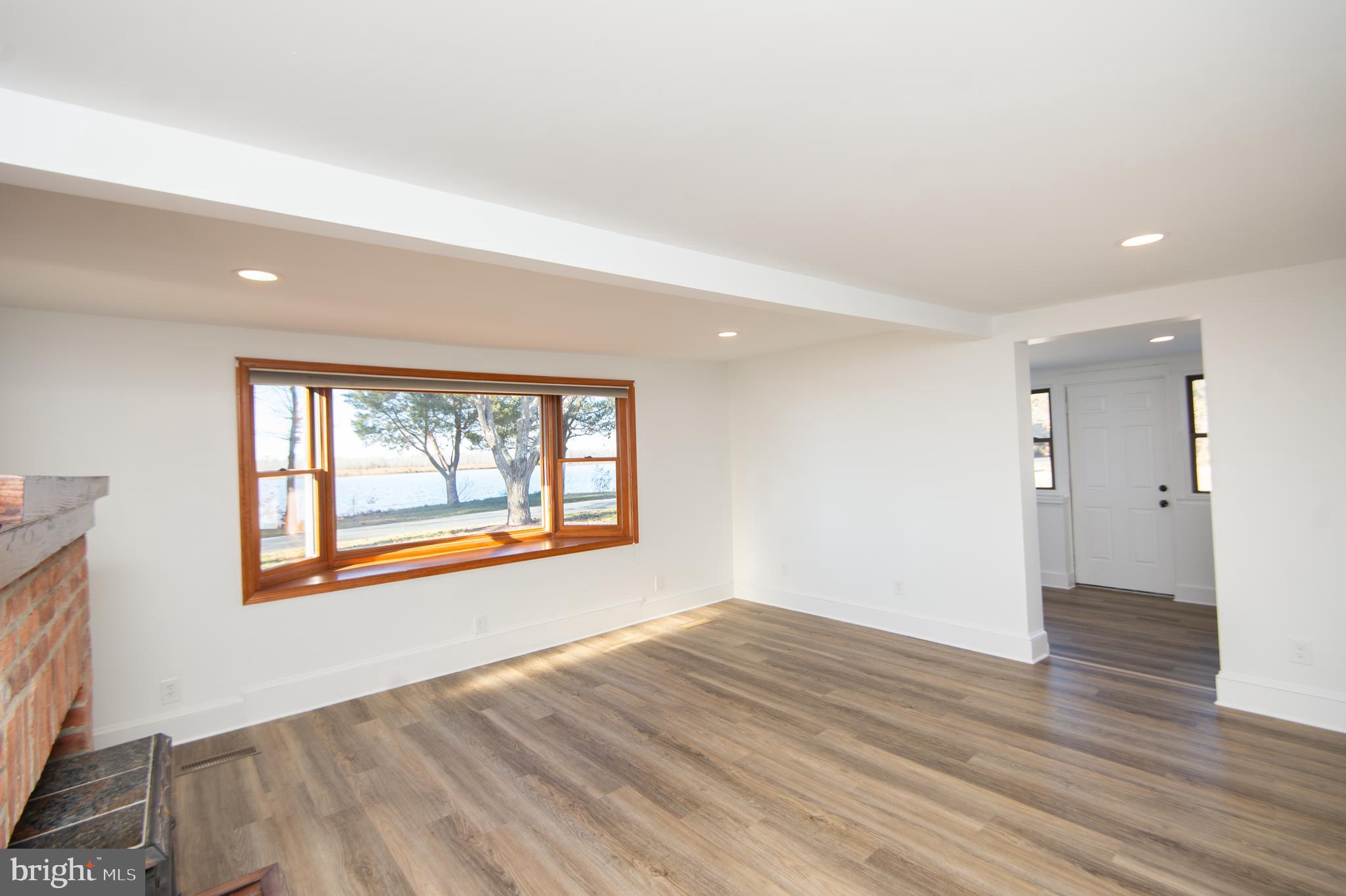 11453 Riverton Road Mardela Springs, MD 21837 - Photo 42 of 71 an empty room with wooden floor and windows