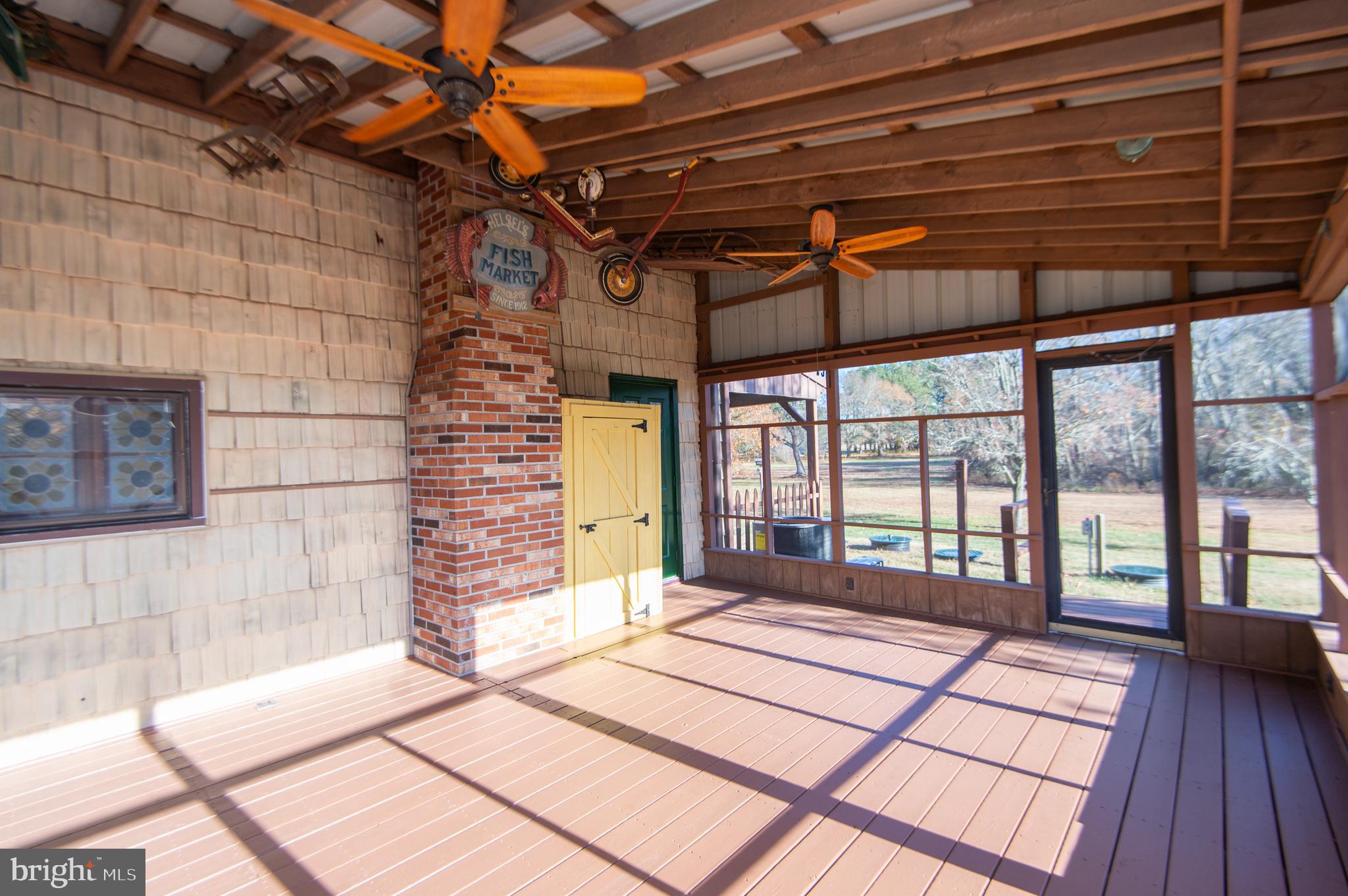 11453 Riverton Road Mardela Springs, MD 21837 - Photo 50 of 71 a view of a porch with wooden floor and a yard