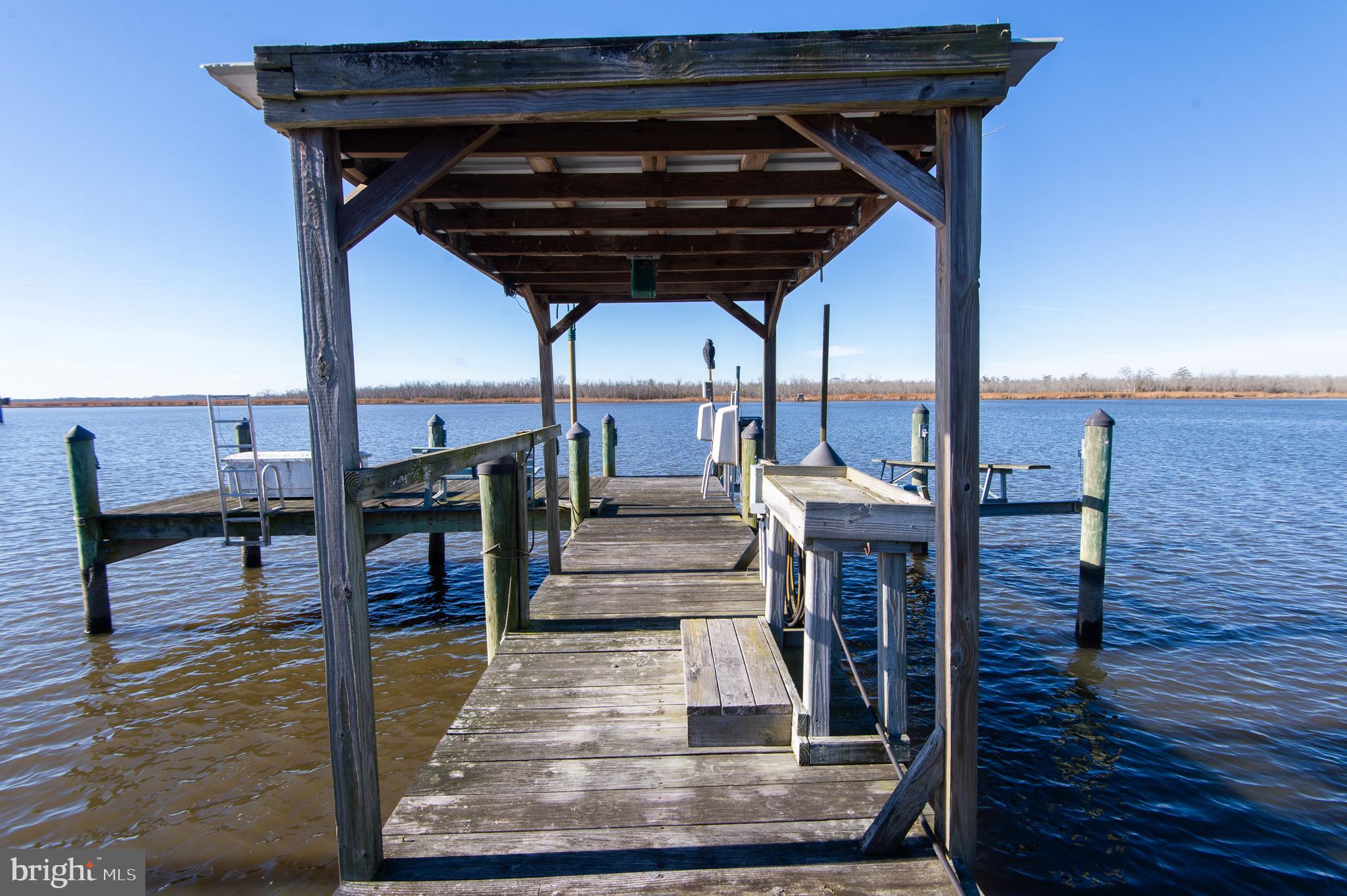 11453 Riverton Road Mardela Springs, MD 21837 - Photo 65 of 71 a view of a porch with furniture and a wooden deck