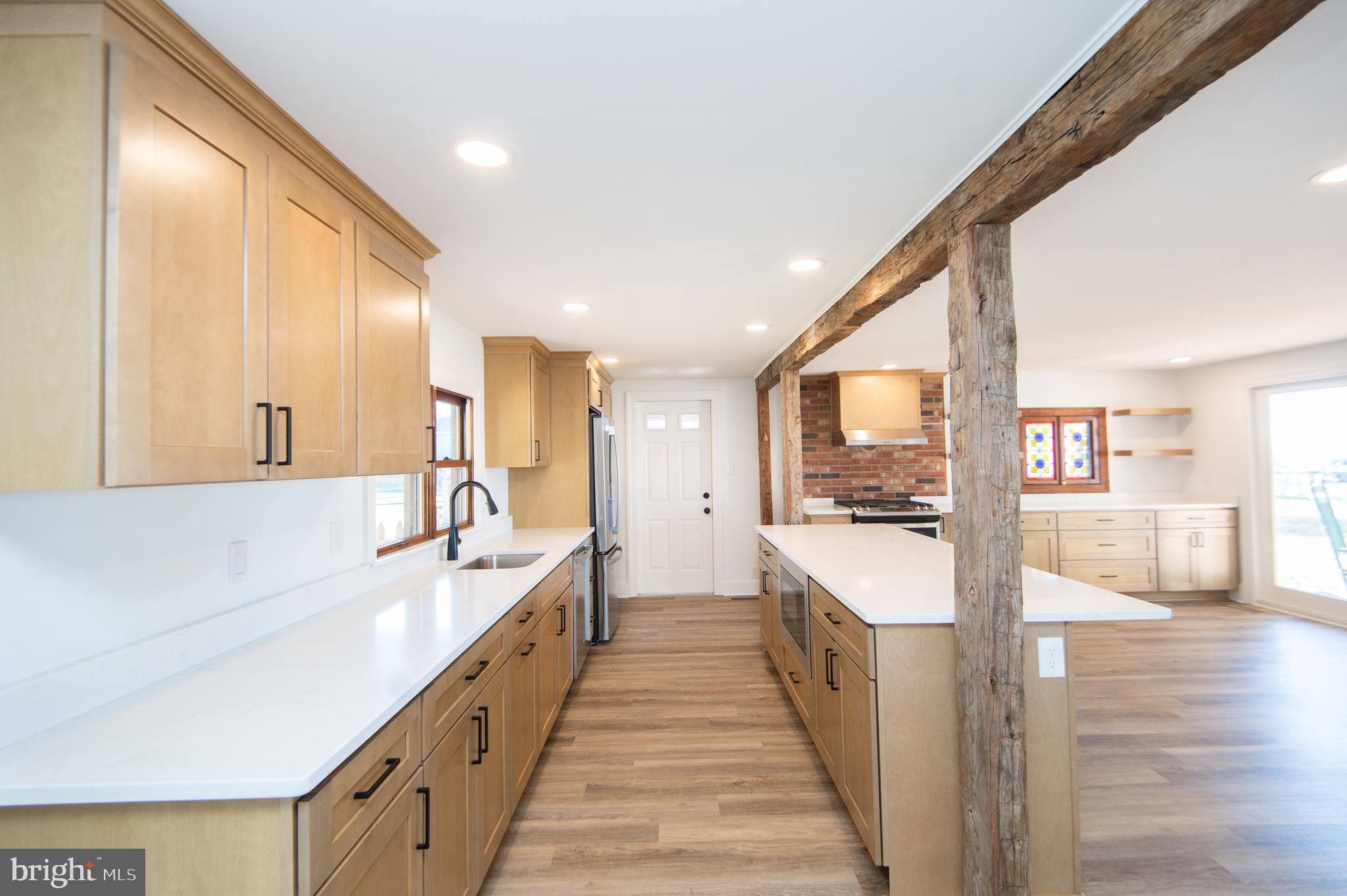 11453 Riverton Road Mardela Springs, MD 21837 - Photo 10 of 71 a large white kitchen with a large window and stainless steel appliances