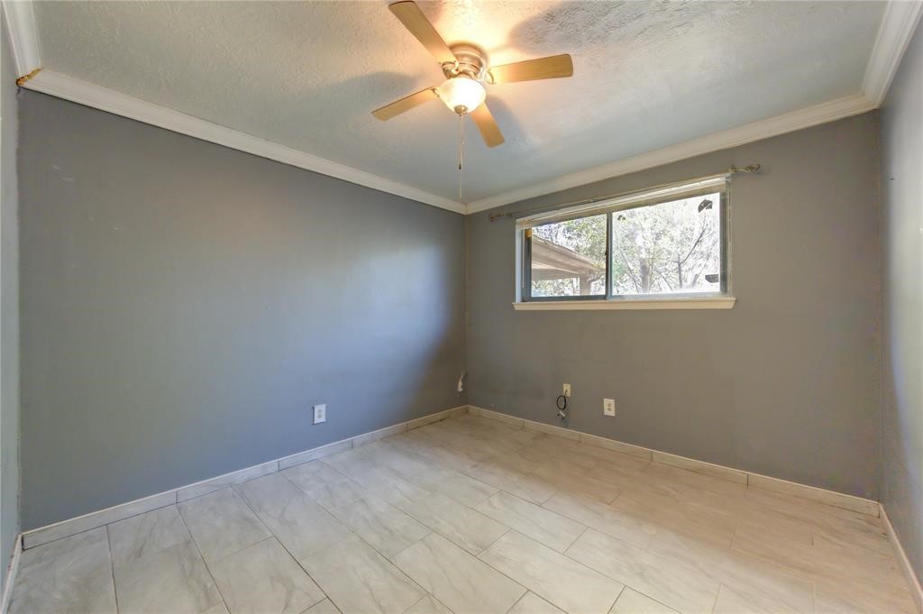 11222 Langdon Lane Houston, TX 77072 - Photo 13 of 20 an empty room with windows and fan