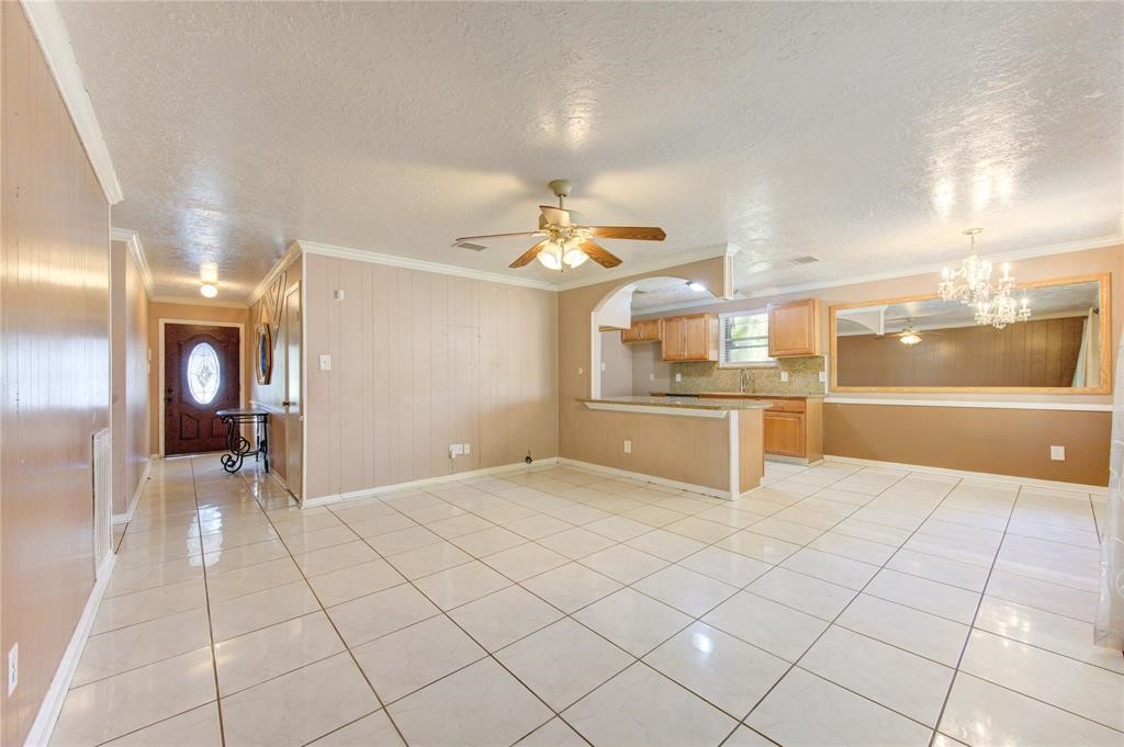 11222 Langdon Lane Houston, TX 77072 - Photo 8 of 20 a large white kitchen with a sink and chandelier