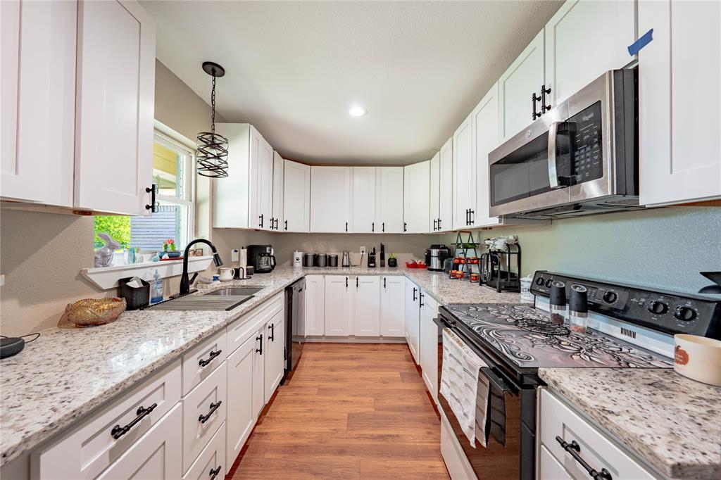 603 Mosley Road Athens, TX 75751 - Photo 3 of 14 a kitchen with stainless steel appliances granite countertop a sink stove and cabinets