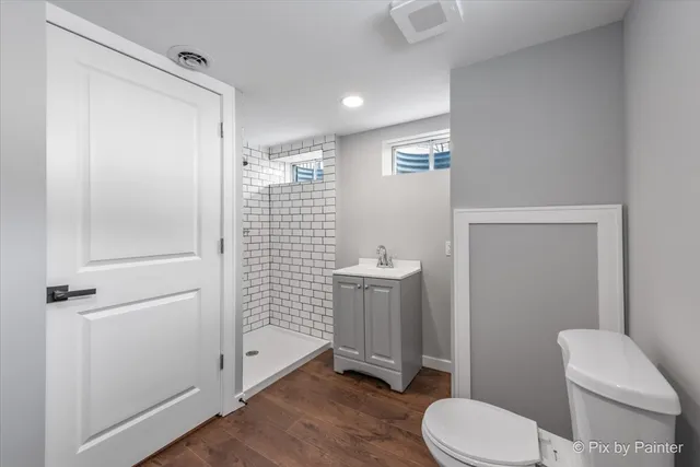a bathroom with a toilet and a shower