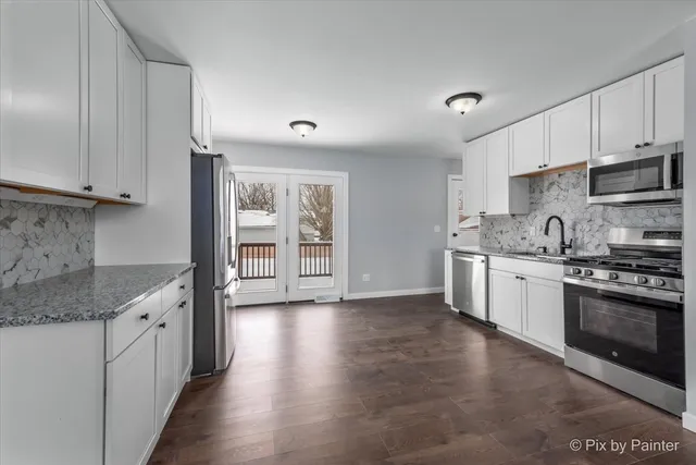 a kitchen with stainless steel appliances granite countertop a stove and a sink