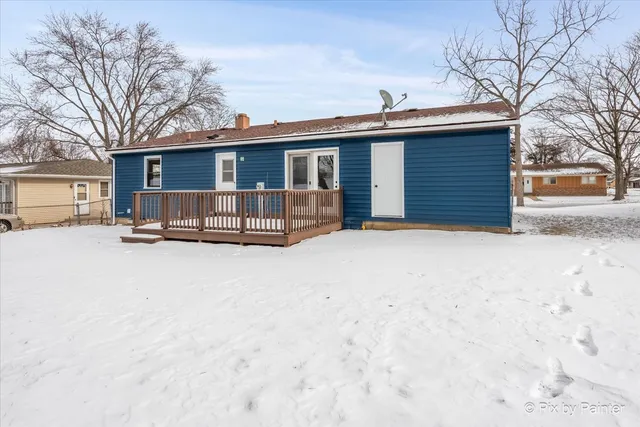 a view of a house with a yard covered in snow