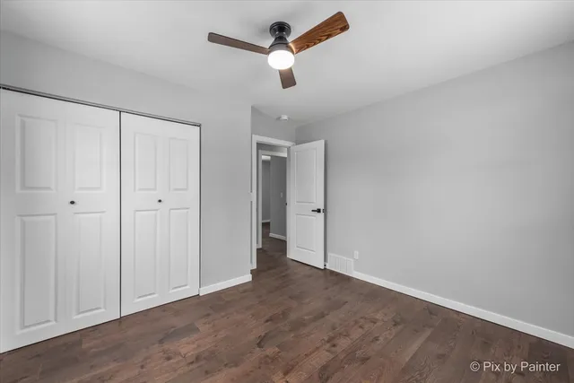 a view of empty room with ceiling fan