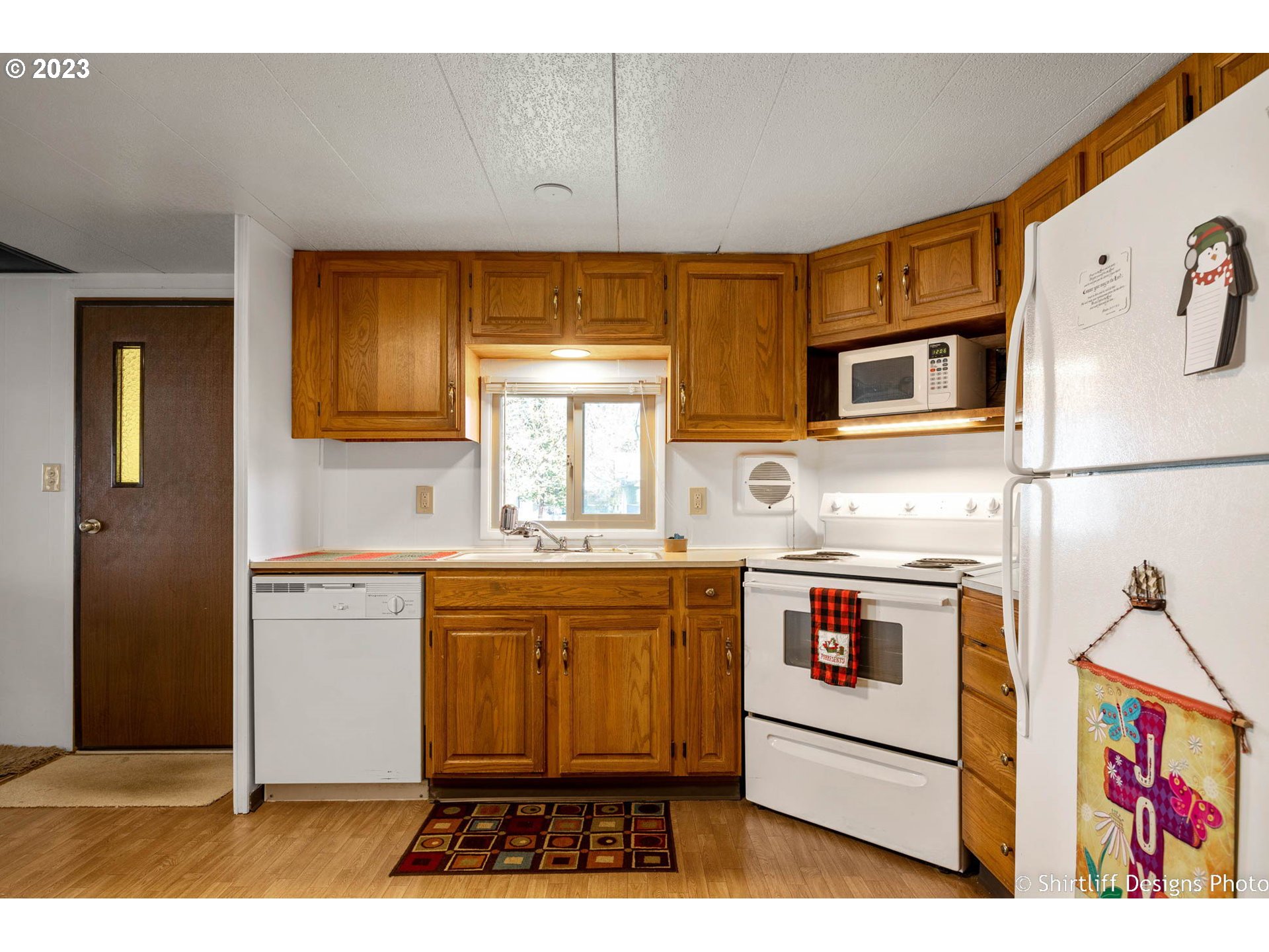 1475 Green Acres Road, Unit 123 Eugene, OR 97408 - Photo 11 of 23 a kitchen with stainless steel appliances granite countertop a stove a sink and a microwave