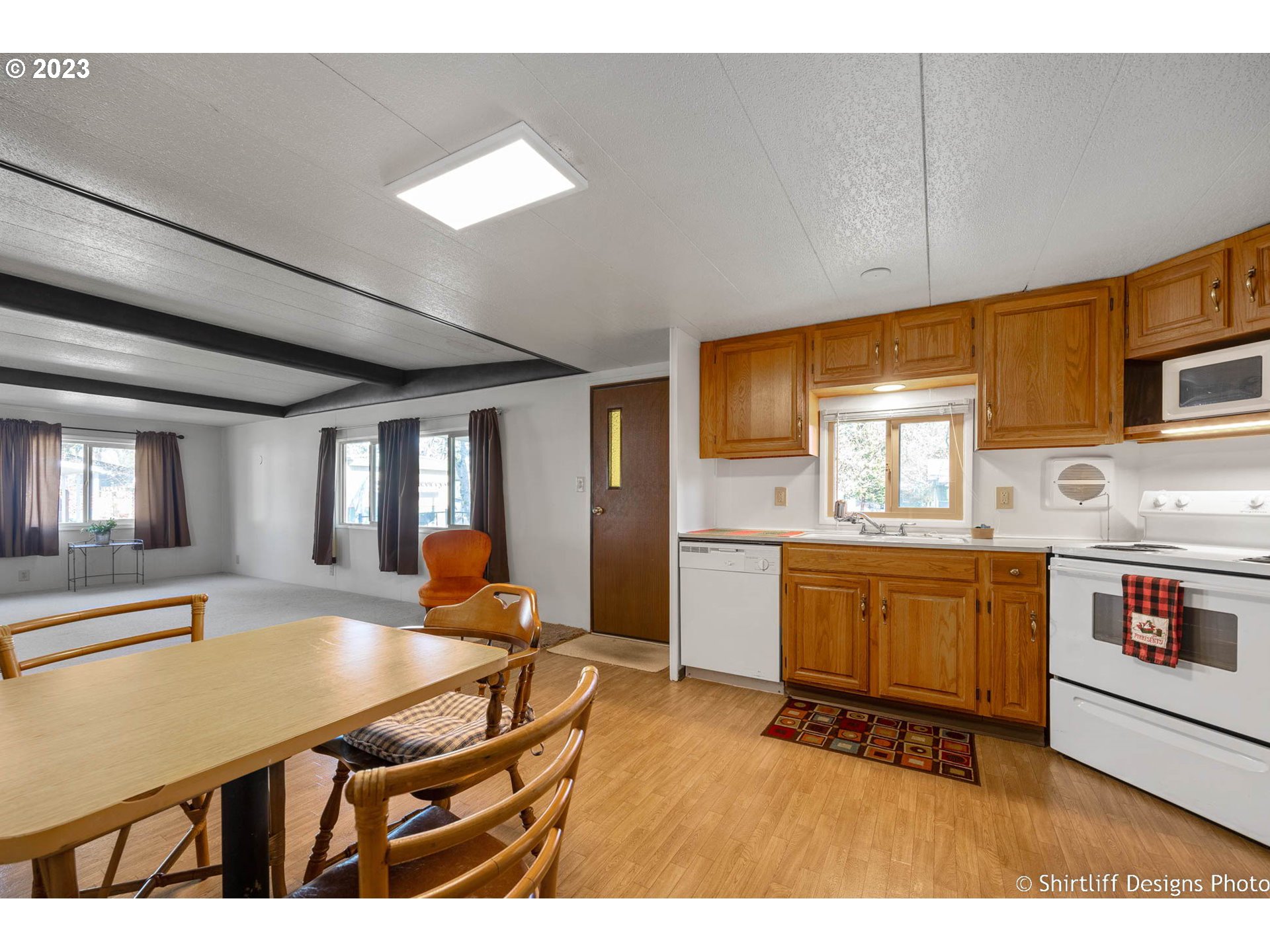 1475 Green Acres Road, Unit 123 Eugene, OR 97408 - Photo 12 of 23 a kitchen with stainless steel appliances kitchen island granite countertop a stove a sink and a refrigerator