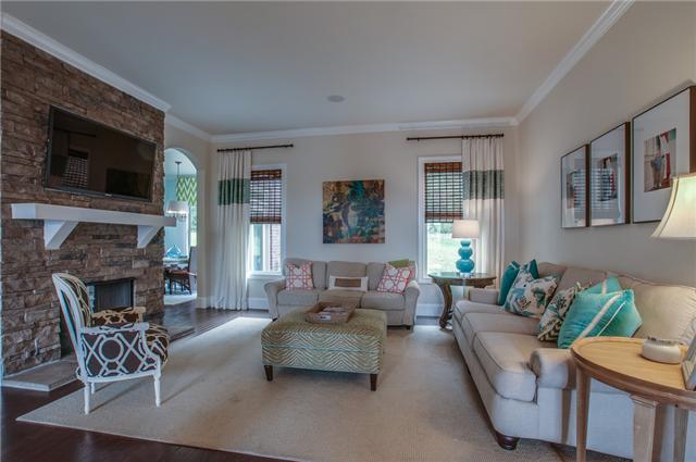 175 Azalea Lane Franklin, TN 37064 - Photo 4 of 20 Living room with stacked stone, double sided fireplace. Tall, arched doorways lead to the kitchen.