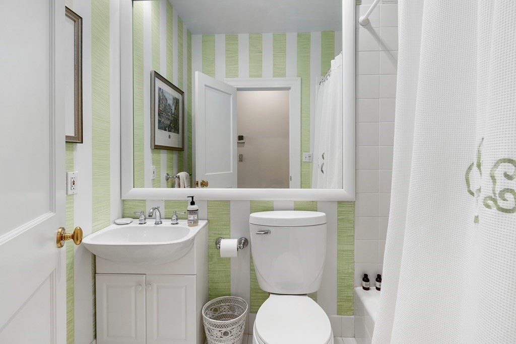 20 Tileston Street, Unit 2H Boston, MA 02113 - Photo 12 of 22 a bathroom with a toilet a sink and a mirror