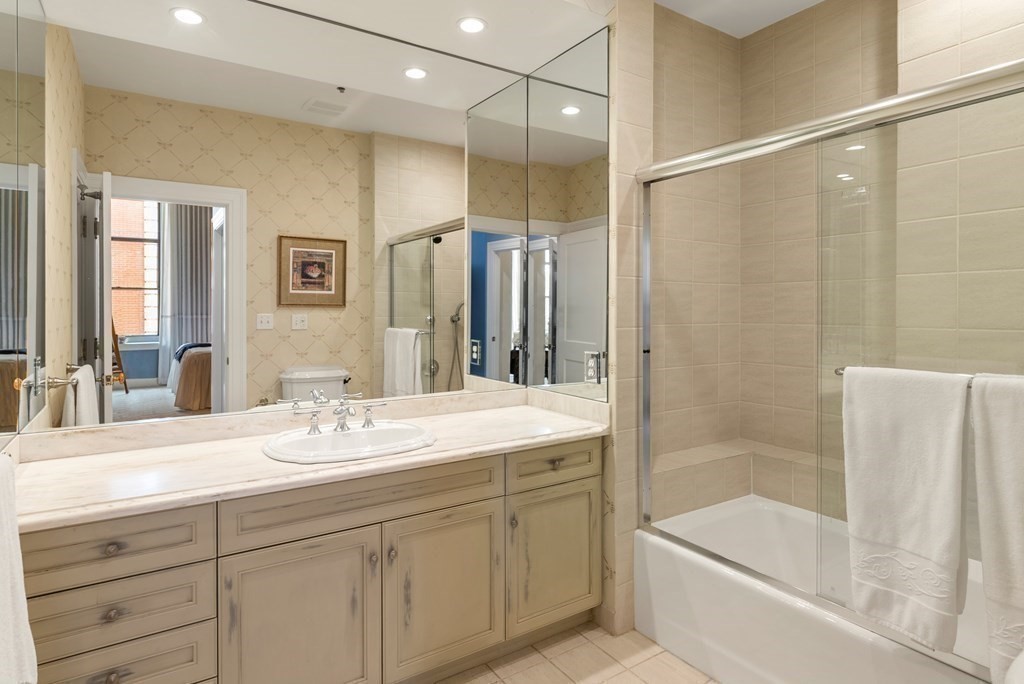 20 Tileston Street, Unit 2H Boston, MA 02113 - Photo 10 of 22 a bathroom with a shower sink vanity and mirror