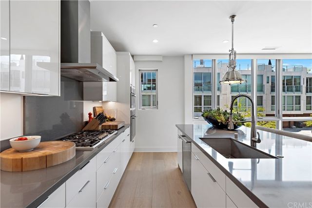 a kitchen with stainless steel appliances kitchen island granite countertop a sink and cabinets
