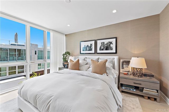 a bedroom with a bed and a large window