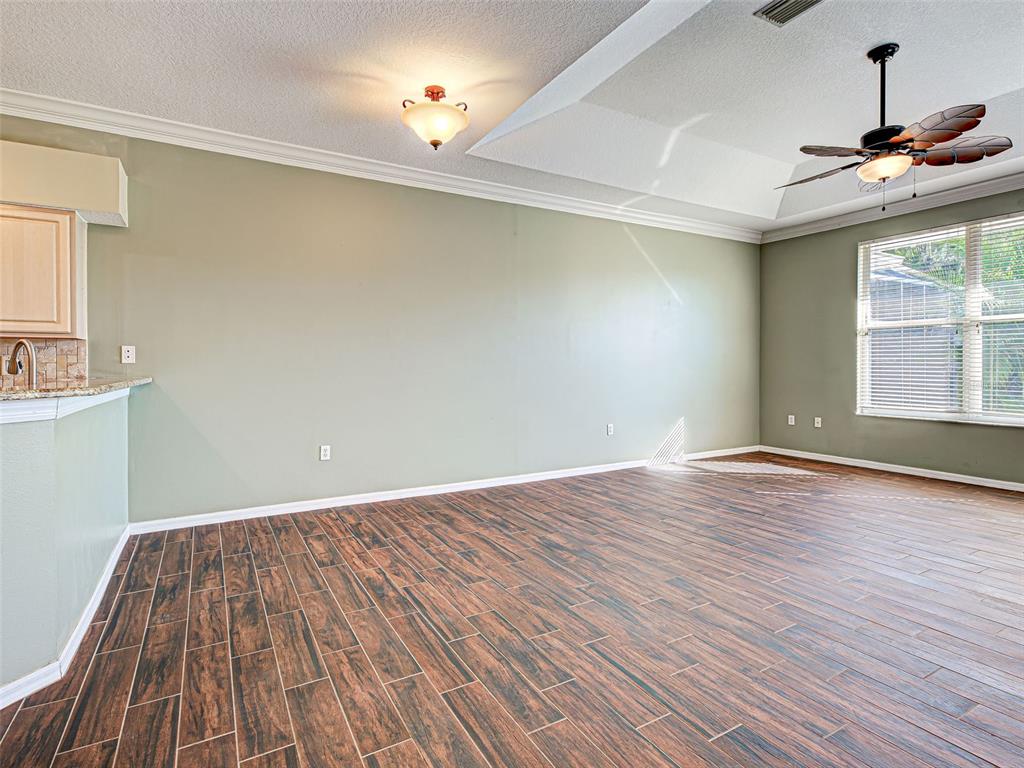 1801 Highland Road Osprey, FL 34229 - Photo 11 of 40 a view of empty room with wooden floor and fan