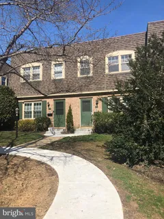 a view of a brick house with a yard