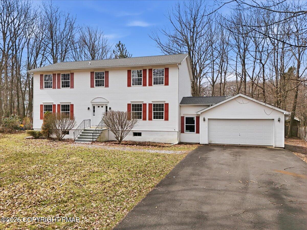12 Devonshire Lane Mount Pocono, PA 18344 - Photo 1 of 39 a house that has a tree in front of it