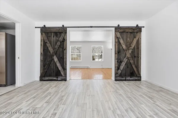a view of a room with wooden floor and a cabinet