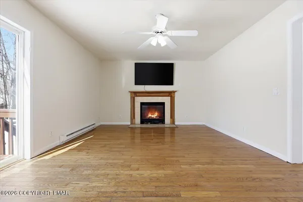 a view of an empty room with a fireplace