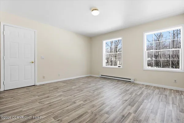wooden floor in an empty room with a window