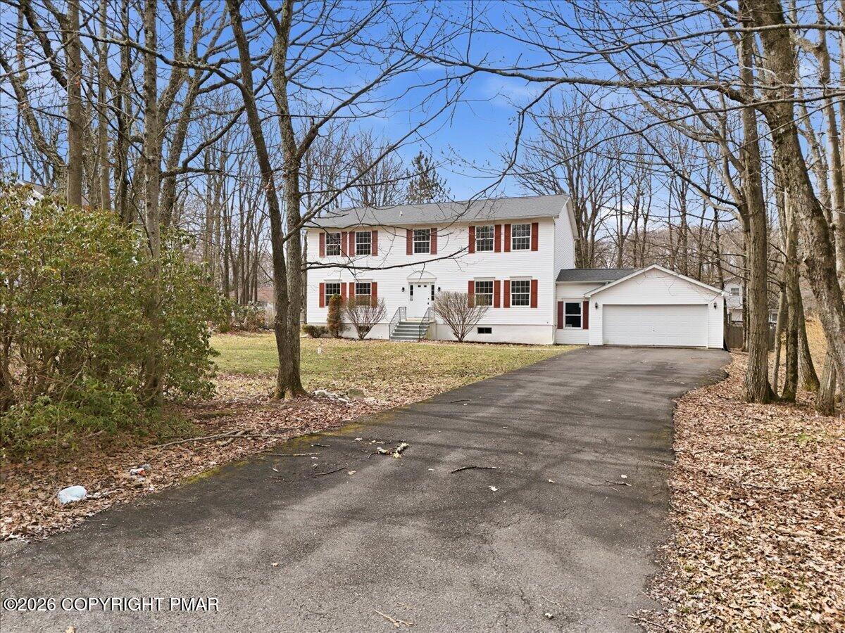 12 Devonshire Lane Mount Pocono, PA 18344 - Photo 2 of 39 a front view of a house with a yard and garage