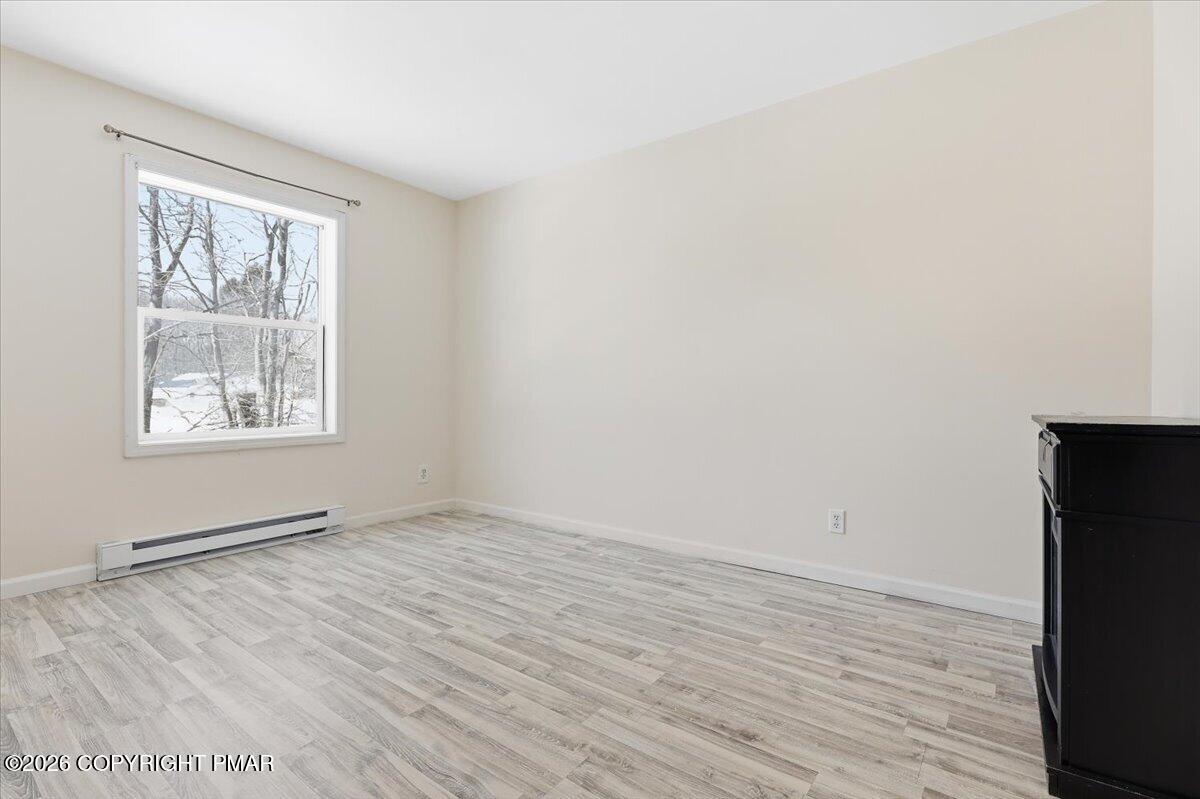 12 Devonshire Lane Mount Pocono, PA 18344 - Photo 23 of 39 an empty room with wooden floor and windows