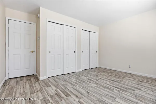 a view of room with wooden floor