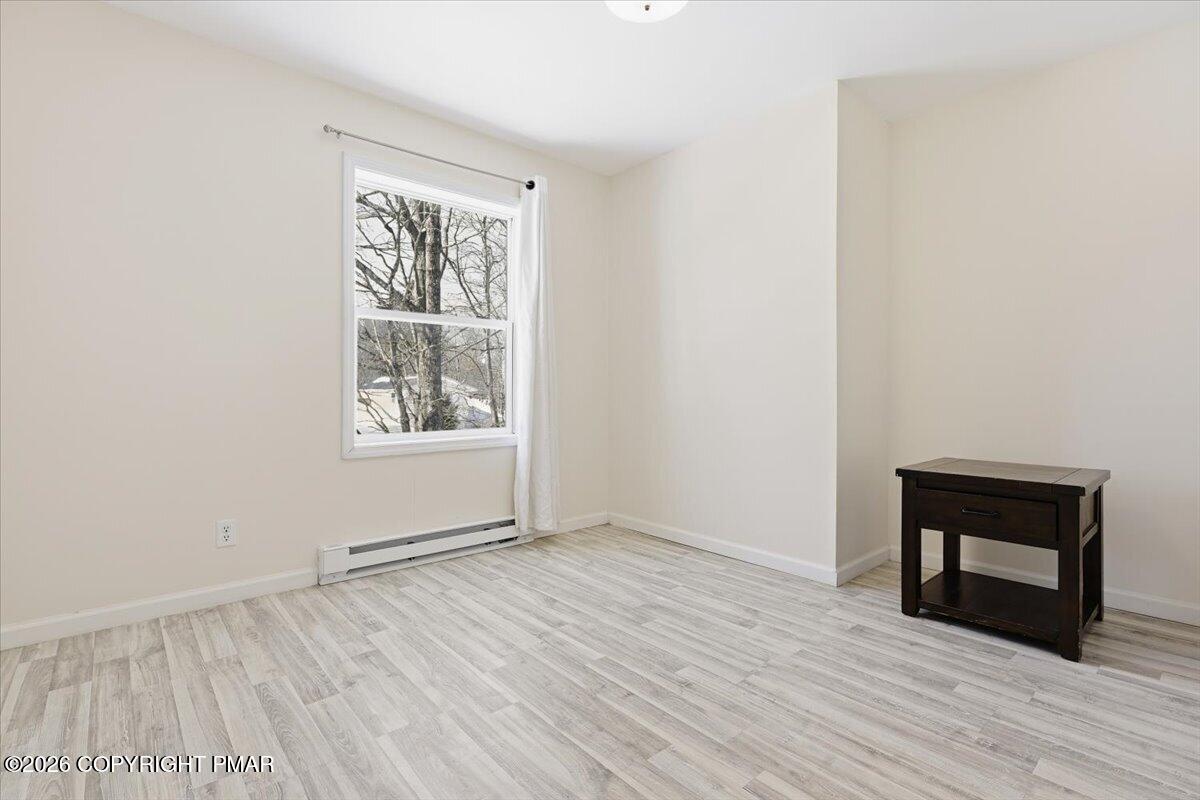 12 Devonshire Lane Mount Pocono, PA 18344 - Photo 25 of 39 an empty room with wooden floor and windows