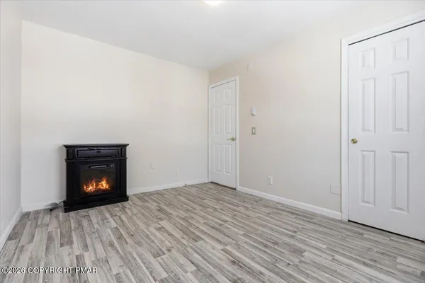 a view of an empty room and wooden floor