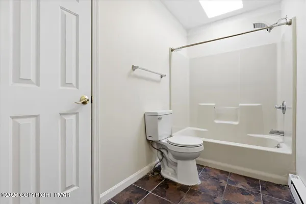 a bathroom with a toilet and shower