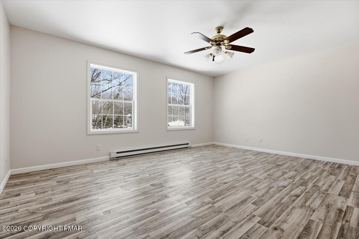 12 Devonshire Lane Mount Pocono, PA 18344 - Photo 29 of 39 an empty room with wooden floor and windows