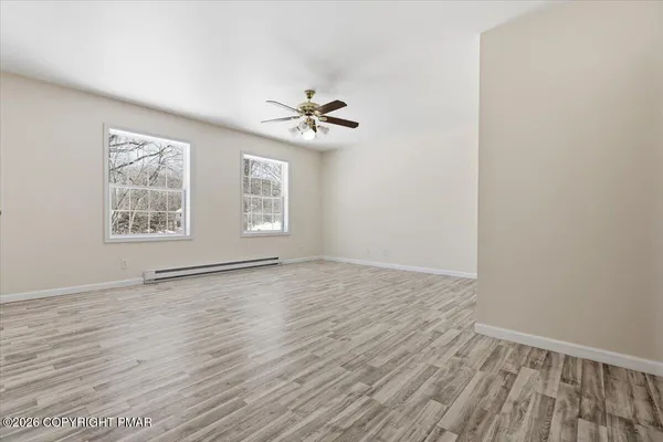 wooden floor in an empty room with a window