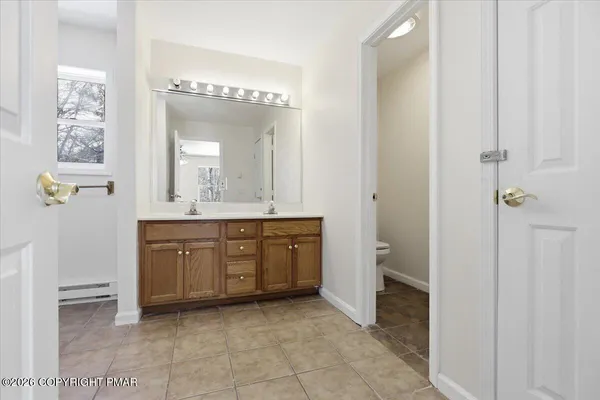 a spacious bathroom with a granite countertop sink a mirror and a