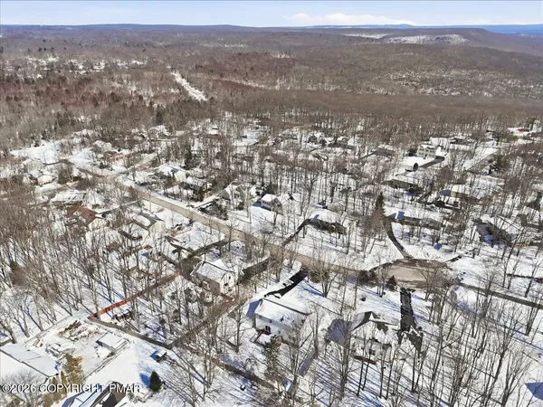 an aerial view of residential houses with city view