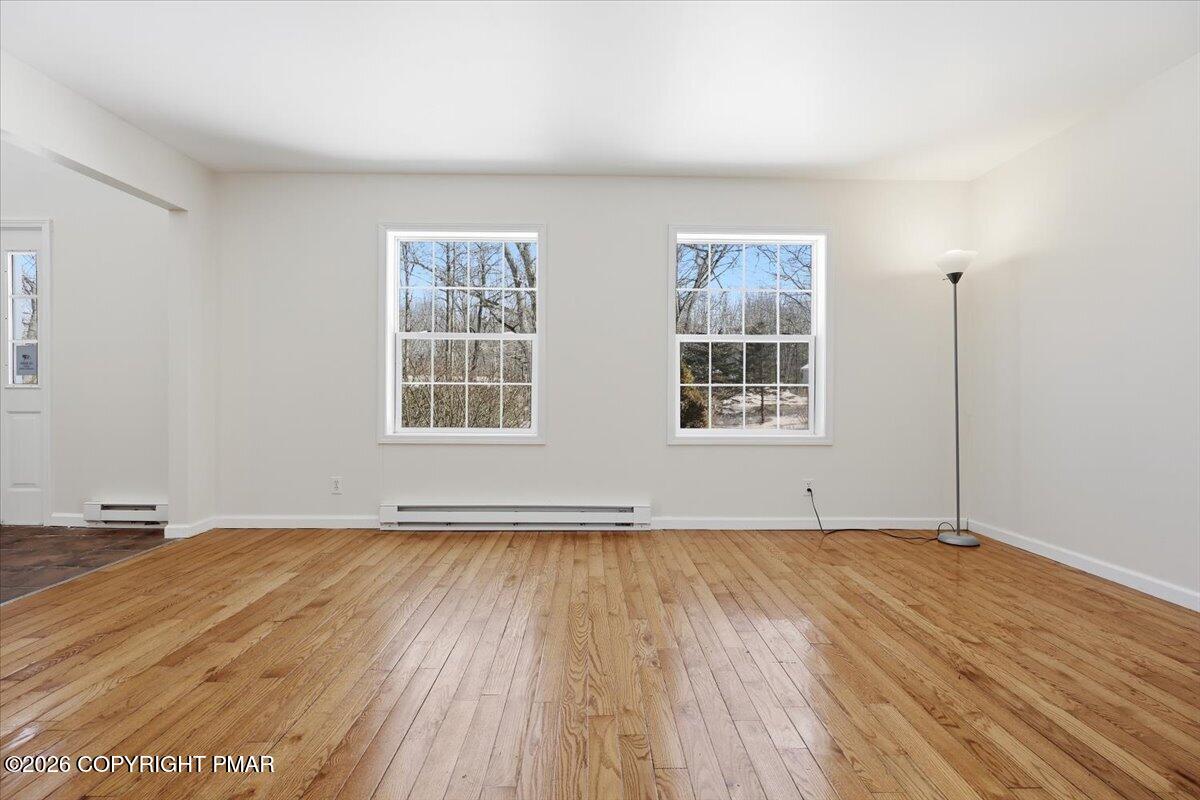 12 Devonshire Lane Mount Pocono, PA 18344 - Photo 6 of 39 an empty room with wooden floor and windows