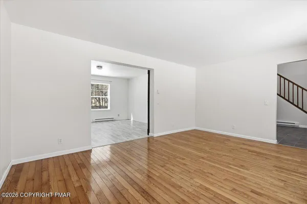 a view of an empty room and wooden floor
