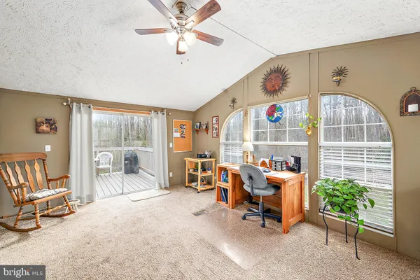 a view of a livingroom with furniture and a window
