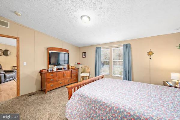 a bedroom with a bed and cabinet