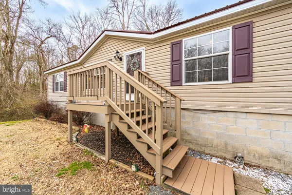 a view of a balcony with wooden floor and fence