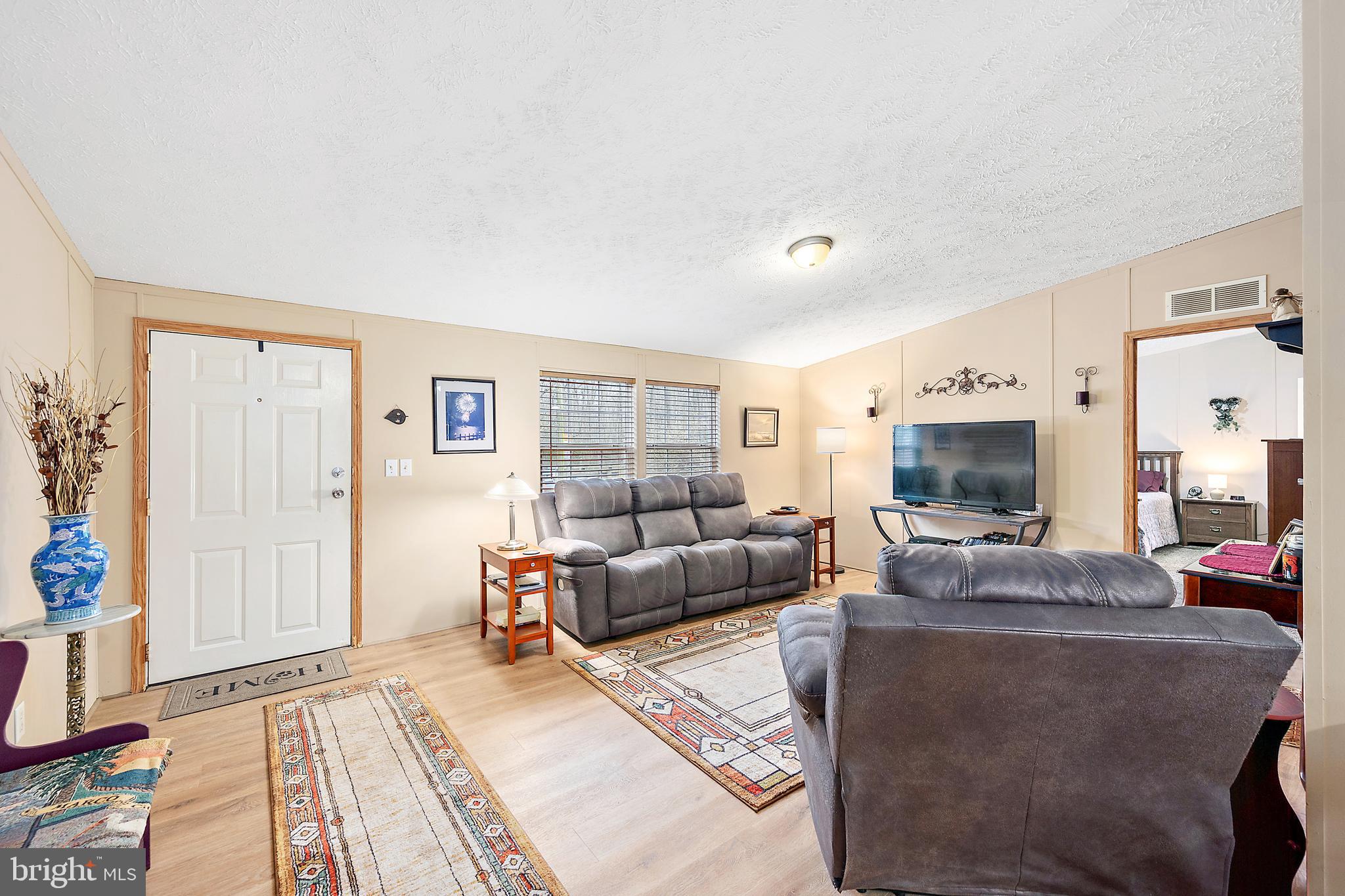 13301 Old Stage Road Bishopville, MD 21813 - Photo 6 of 43 a living room with furniture and a flat screen tv