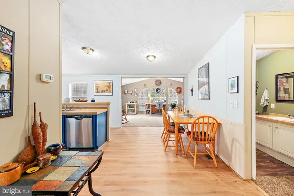 a living room with furniture a flat screen tv and a dining table